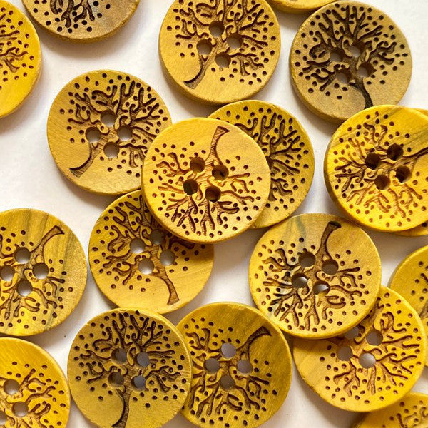 Yellow wood button with laser tree