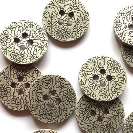 Zinc colour button with floral pattern